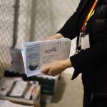 A city election work handles envelopes from the Oct. 3 municipal election at the City and Borough of Juneau Ballot Processing Center leading up the scheduled Oct 17 certification of results. (Clarise Larson / Juneau Empire File)