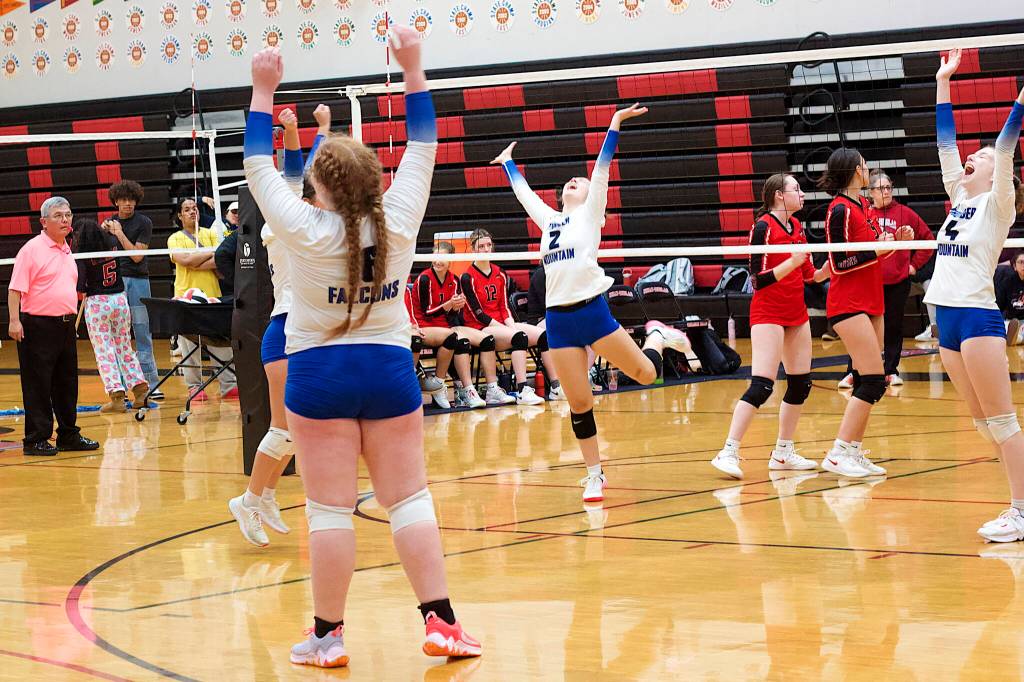 Thunder Mountain High School players celebrate making it to the title game of the Juneau Invitational Volleyball Extravaganza at Juneau-Douglas High School: Yadaa.at Kalé after defeating JDHS in the play-in game on Saturday. (Mark Sabbatini / Juneau Empire)