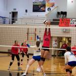 Chugiak High Schools Catheryn Townsend deflects the ball back across the net against Thunder Mountain High school during the championship game of the Juneau Invitational Volleyball Extravaganza at Juneau-Douglas High School: Yadaa.at Kalé on Saturday. (Mark Sabbatini / Juneau Empire)