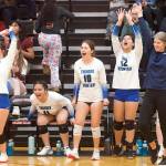 Thunder Mountain High School volleyball coach Julie Herman, right, celebrates with her players as they take a late lead over Chugiak High School in the second set of the championship game of the Juneau Invitational Volleyball Extravaganza at Juneau-Douglas High School: Yadaa.at Kalé on Saturday. (Mark Sabbatini / Juneau Empire)