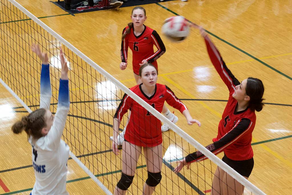 Juneau-Douglas High School: Yadaa.at Kalés Kiah Yadao (5) knocks the ball past Thunder Mountain High Schools Jenna Dobson during their semifinal game in the Juneau Invitational Volleyball Extravaganza at JDHS on Saturday. (Mark Sabbatini / Juneau Empire)