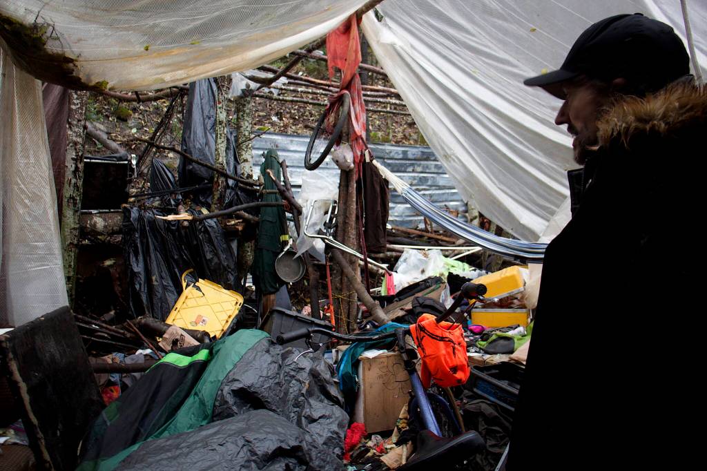 Fate Wilson examines the interior of his shelter at Mill Campground on Sunday, which was ransacked recently by a bear. Residents at the campground said bears have been a constant problem and resulted in numerous people leaving the campground before it closed for the season Monday. (Mark Sabbatini / Juneau Empire)