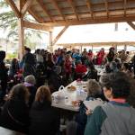 Stephanie Harold creates sketches among a crowd at the annual Traditional Food Fair in Hoonah on Sept. 9. (Photo by Ian Johnson)