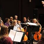 Christopher Koch, musical director for Juneau Symphony, faces members of the viola and cello sections during rehearsals of Candide Tuesday evening at Juneau-Douglas High School: Yadaa.at Kalé. Performances at JDHS are scheduled Saturday at 7:30 p.m. and Sunday at 3 p.m. (Meredith Jordan/ Juneau Empire)