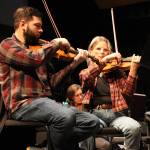 Violinists Franz Felkl and Lisa Ibias of the Juneau Symphony focus on their parts in Candide at rehearsal on Tuesday at Juneau-Douglas High School: Yadaa.at Kalé. (Meredith Jordan/ Juneau Empire)