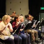 Candide cast members Skiba Wuoti (Cunegonde) and Steven Arends (Maximilian) stand in the wings watching the woodwind section rehearse on Tuesday at Juneau-Douglas High School: Yadaa.at Kalé. (Meredith Jordan/ Juneau Empire)