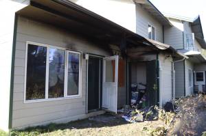 The back side of a unit in an apartment complex at 2800 Postal Way that caught fire on Sunday evening. No one was injured in the blaze, which left its occupant temporarily homeless and a neighbors home with smoke damage. (Meredith Jordan/ Juneau Empire.)