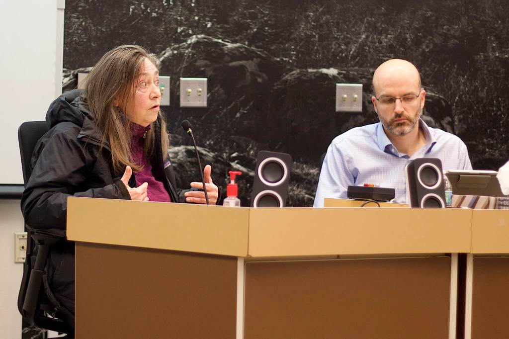 Maureen Conerton, testifies in opposition to four proposed plans for the redevelopment of Telephone Hill as Deputy City Manager Robert Barr listens during Monday nights Juneau Assembly meeting. (Mark Sabbatini)