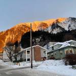Sunlight is cast over part of Mount Juneau on Dec. 16, 2021. (Michael S. Lockett / Juneau Empire File)