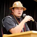 X̱ʼunei Lance Twitchell, a language professor at the University of Alaska Southeast, discusses the collaborative writing process of Kuhaantí during the Lingít-language books release event at Elizabeth Peratrovich Hall on Friday night. (Mark Sabbatini / Juneau Empire)