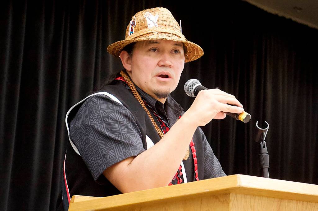 X̱ʼunei Lance Twitchell, a language professor at the University of Alaska Southeast, discusses the collaborative writing process of Kuhaantí during the Lingít-language books release event at Elizabeth Peratrovich Hall on Friday night. (Mark Sabbatini / Juneau Empire)