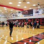 Juneau-Douglas High School: Yadaa.at Kalé volleyball coach Jody Levernier takes a photo of players who are joined by family and friends during Senior Night on Saturday at JDHS. (Mark Sabbatini / Juneau Empire)