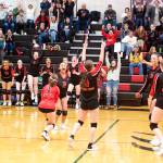 The Juneau-Douglas High School: Yadaa.at Kalé varsity volleyball team celebrates a comeback five-set win against Ketchikan High School on Saturday night at JDHS. Ketchikan won the first two sets before JDHS won the next three, all by close back-and-forth scores until the fifth set which the Crimson Bears won decisively. (Mark Sabbatini / Juneau Empire)