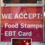 A sign for a store that accepts food stamps and exchange benefits transfer cards is seen in this 2019 photo. Alaska has being going through a year-long crisis in processing applications for benefits. (Photo by Scott Heins/Getty Images)
