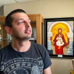 Dmytro Haiman looks out the window from the Ukrainian Cultural Institute in Dickinson, N.D., on Monday, July 17, 2023. Haiman is one of several Ukrainians who are part of a pilot effort of the North Dakota Petroleum Councils Bakken Global Recruitment of Oilfield Workers program. Haiman is from Chernihiv, Ukraine. (AP Photo/Jack Dura)