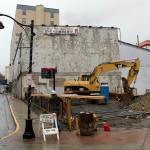 Heavy equipment is parked next to the old Elks Lodge building at 109 S. Franklin St. when an add-on structure to the original 1908 building was still standing. On Wednesday afternoon that part of the structure and a wall portion of the original building had been demolished. (Mark Sabbatini / Juneau Empire)