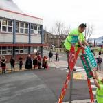 Randal Jim (center) and Joey Ludlam replace a Seward St. with a Heritage Way sign at midday Wednesday, the day the new name became official for a two-block portion of the downtown street. About 50 local tribal leaders, city officials and others attended a ceremony at Sealaska Plaza marking the name change effort that originated in April. (Mark Sabbatini / Juneau Empire)