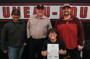 Juneau-Douglas High School: Yadaa.at Kalé senior Lamar Blatnick signed a letter of intent Wednesday in the JDHS gymnasium to play baseball for Dallas Christian College. From left are father and assistant coach Larry Blatnick, assistant coach Erik McCormick, Lamar Blatnick and JDHS head coach Chad Bentz. (Klas Stolpe for the Juneau Empire)