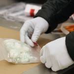 A tag is place on a evidence bag containing small baggies of drugs seized by the Juneau Police Department. (Ben Hohenstatt / Juneau Empire File)