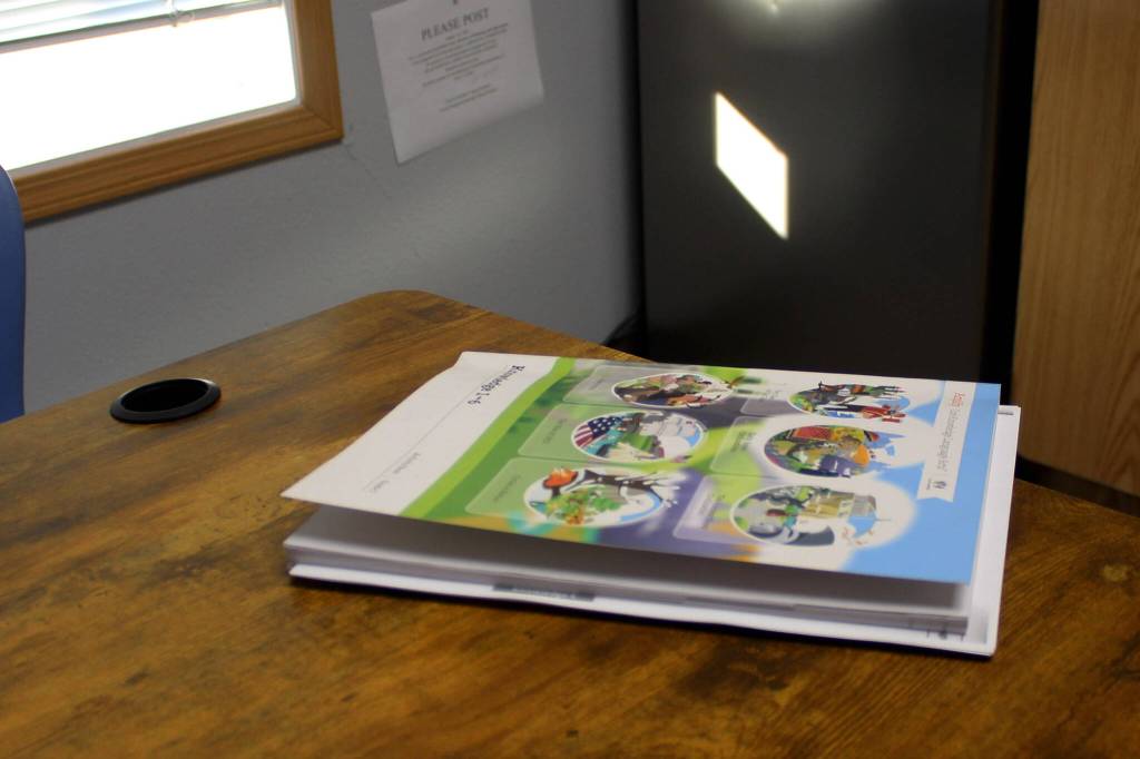 An Amplify CKLA book rests on Principal Dr. Mike Sturms desk at Razdolna School on Tuesday, Oct. 24, 2023, in Razdolna, Alaska. (Ashlyn OHara/Peninsula Clarion)