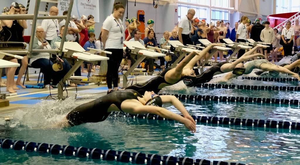 Thunder Mountain High School senior Gabrielle Anderson and Juneau-Douglas High School: Yadaa.at Kalé senior Samantha Schwarting are shown in the start of the girls 200-yard medley relay during the ASAA State Swim & Dive Championships on Saturday at the Dimond Park Aquatic Center. (Klas Stolpe / For the Juneau Empire)