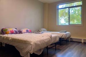 Freshly made beds are seen in an unoccupied room at the Fairbanks emergency shelter, Interior Alaska center for Non-Violent Living on Oct. 14. (Claire Stremple/Alaska Beacon)