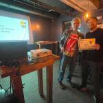 Devils Club Brewing Company brewer Trever Held accepts an award at the 2023 AK Beer Awards competition at Williwaw Social in Anchorage on Nov. 3. (Photo courtesy of Brewers Guild of Alaska)