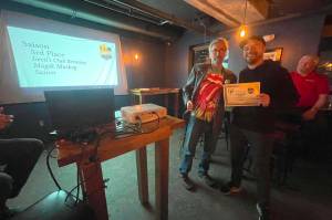 Devils Club Brewing Company brewer Trever Held accepts an award at the 2023 AK Beer Awards competition at Williwaw Social in Anchorage on Nov. 3. (Photo courtesy of Brewers Guild of Alaska)
