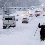 Jodie Gallamore cross-country skis along Tudor Road after a heavy snowfall in Anchorage on Thursday. Her dog Yum Yum followed closely behind. Gallamore said shes fine with the conditions. I love it. Im sorry Anchorage, she said. Four homeless people have died in Anchorage in the last week, underscoring the citys ongoing struggle to house a large houseless population at the same time winter weather has returned, with more than 2 feet (0.61 meters) of snow falling within 48 hours.(Marc Lester/Anchorage Daily News via AP)