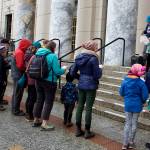 About 15 people sing on the steps of the Alaska State Capitol during an Armistice Day observation on Saturday hosted by Juneau Veterans for Peace. (Mark Sabbatini / Juneau Empire)