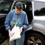 Mickey Lesley, a cryptographer during the Korean War, on Saturday shows a book published from a notebook she kept during her subsequent adventures over decades in Alaska. She said she acquired the habit of writing letters and journals during her service when, lacking family to write weekly letters to as the military demanded, instead wrote to the orphanage where she was raised. (Mark Sabbatini / Juneau Empire)