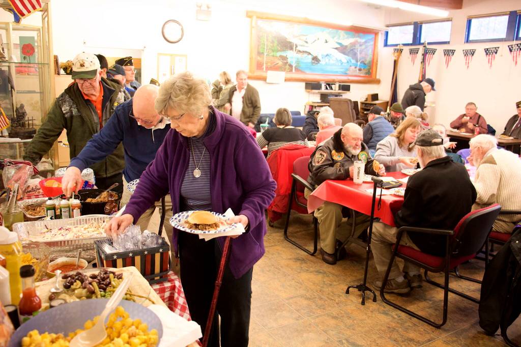 Military veterans, family members and others gather at American Legion Auke Bay Post 25 at midday Saturday for an annual Veterans Day lunchtime gathering. (Mark Sabbatini / Juneau Empire)