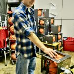 George Houston pumps up basketballs in preparation for the Carlos Boozer Alaska Basketball Camp in 2009. (Klas Stolpe for the Juneau Empire)