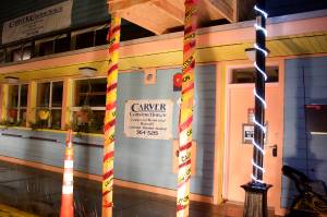 Caution tape and warning signs at the former Glory Hall shelter on South Franklin Street on Monday alert passerbys to construction that begin earlier this month, with seven housing units and additional commercial space scheduled for completion by next summer. (Mark Sabbatini / Juneau Empire)