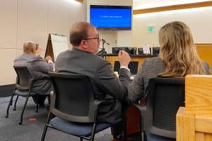 Prosecutors Daniel K. Shorey and Kate Tallmadge (foreground) confer, as defense attorney Rex Butler and Sonya Taton await proceedings during Tatons trial Thursday on murder and other charges at Superior Court in Juneau. (Meredith Jordan / Juneau Empire)
