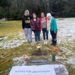 Gregory Bowens family  Wade Bowen, Alexandria Roehl, Mabel Pittman, Alexandra Pittman  seen here at his marker at Alaskan Memorial Park and Legacy Funeral Homes after the verdict Friday in the trial of Sonya Taton, who was convicted of stabbing Bowen to death. Pittman had the banner redone before the trial started. (Photo by Jack Tullis, courtesy of Mabel Pittman.)