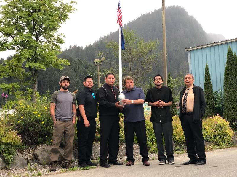 Friends and family of Greg Bowen hold his ashes on the day of his service in 2019. The ashes were spread at the seine hooks Greg mastered and other spots he loved, said Barbara Nelson. From left to right, Bill Peters, Matt See, Nicholas Nelson, Norval Nelson, Wade Bowen, Michael Corpuz. (Photo courtesy of Barbara Cadiente-Nelson.)