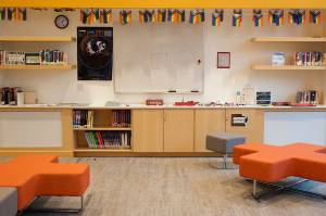 A row of rainbow flags are displayed above the bookshelves in the teen room at the Mendenhall Valley Public Library. (Mark Sabbatini / Juneau Empire)