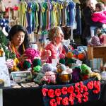 Rebecca Hsieh, left, knits small gifts as a first-time vendor at the Juneau Public Market as her friend, MK MacNaughton, a longtime vendor sells hand-painted items near the entrance of Centennial Hall on Nov. 26, 2022. (Mark Sabbatini / Juneau Empire File)
