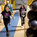 Casey Blackwell, 10, crosses the finish line after running 27 laps around the indoor track at Dimond Park Field House to complete the 5K Pajama Jog on Sunday. (Mark Sabbatini / Juneau Empire)