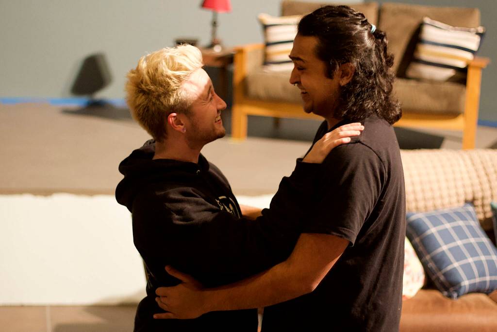 Jack Scholz, left, and Tristan Cameron reconcile in a rehearsal scene of A Nice Indian Boy at Perseverance Theatre on Tuesday night. (Mark Sabbatini / Juneau Empire)