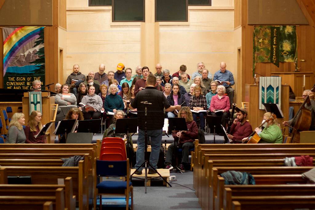 Chorus members and instrumentalists rehearse a portion of Handels Messiah together for the first time on Wednesday evening at Ḵunéix̱ Hídi Northern Light United Church in preparation for concerts Saturday and Sunday. (Mark Sabbatini / Juneau Empire)