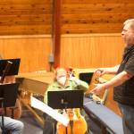 Rich Moore conducts the finale of the Hallelujah Chorus during a rehearsal of Handels Messiah on Wednesday evening at Ḵunéix̱ Hídi Northern Light United Church. (Mark Sabbatini / Juneau Empire)