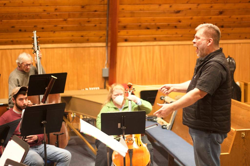 Rich Moore conducts the finale of the Hallelujah Chorus during a rehearsal of Handels Messiah on Wednesday evening at Ḵunéix̱ Hídi Northern Light United Church. (Mark Sabbatini / Juneau Empire)