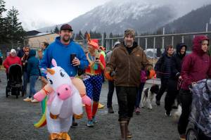 Participants, many clad in fowl weather gear, head out onto the Airport Dike Trail during the annual Turkey Trot 5K and 1 Mile Fun Run on Thursday morning. (Mark Sabbatini / Juneau Empire)