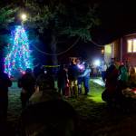 About 50 people watch the lighting of the Christmas tree outside Douglas Community United Methodist Church on Friday night. (Mark Sabbatini / Juneau Empire)
