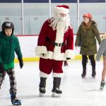 Santa mingles among the crowd on the rink at Treadwell Arena on Friday night. (Mark Sabbatini / Juneau Empire)