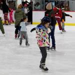 Skaters seek to find balance during the holiday season during the annual Santa Skate at Treadwell Arena on Friday night. (Mark Sabbatini / Juneau Empire)