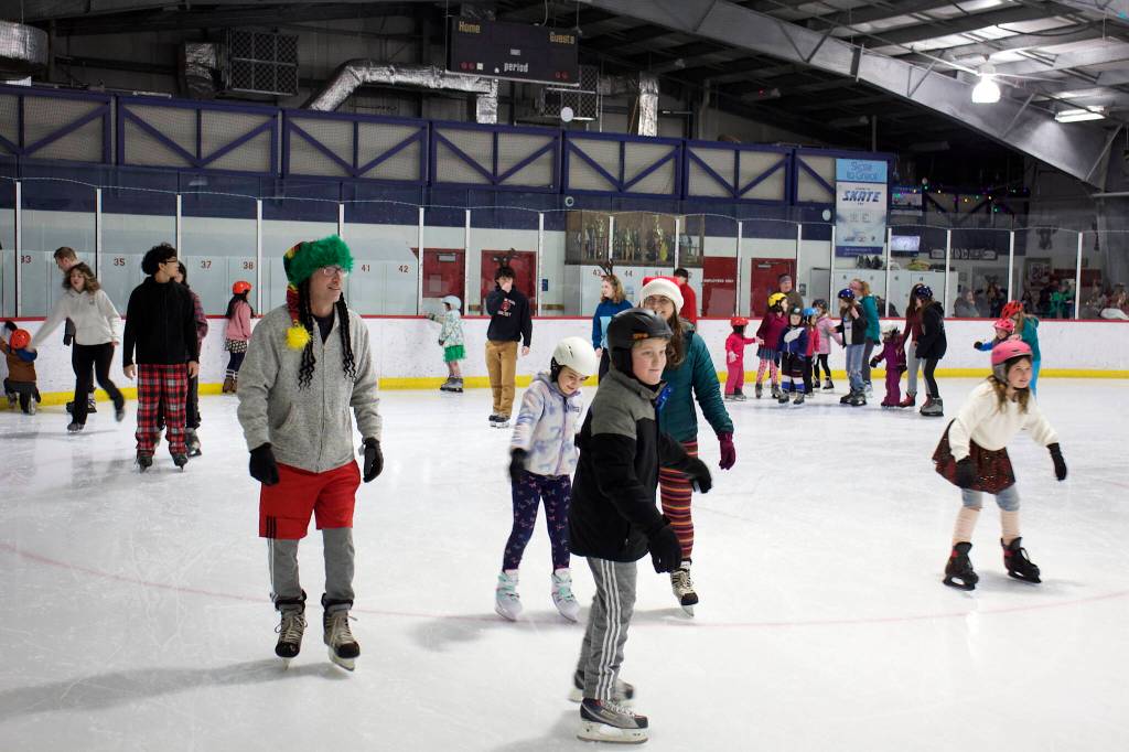 Hundreds of people pack into Treadwell Arena on Friday night for the annual Santa Skate. (Mark Sabbatini / Juneau Empire)