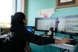 Charlene Apok leads Data for Indigenous Justice and works with the states Maternal Child Death Review to understand maternal mortality in Alaska. Apok analyzed data in their office on Sept. 25. (Photo by Claire Stremple/Alaska Beacon)